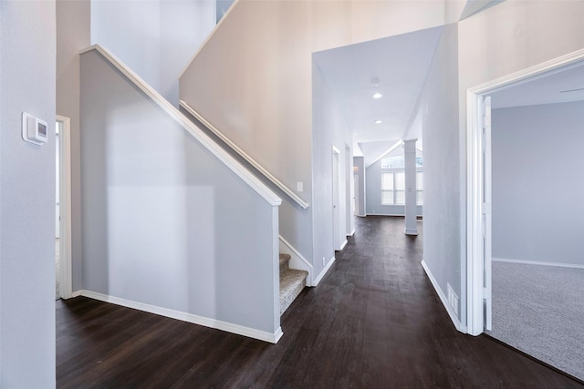 corridor featuring dark hardwood / wood-style floors and high vaulted ceiling