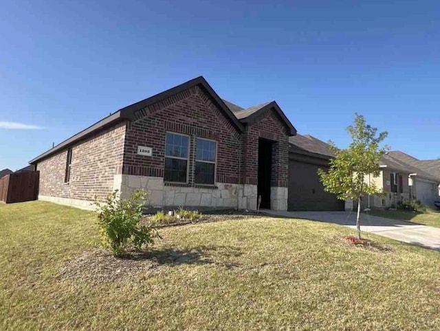 view of front of home with a garage and a front lawn