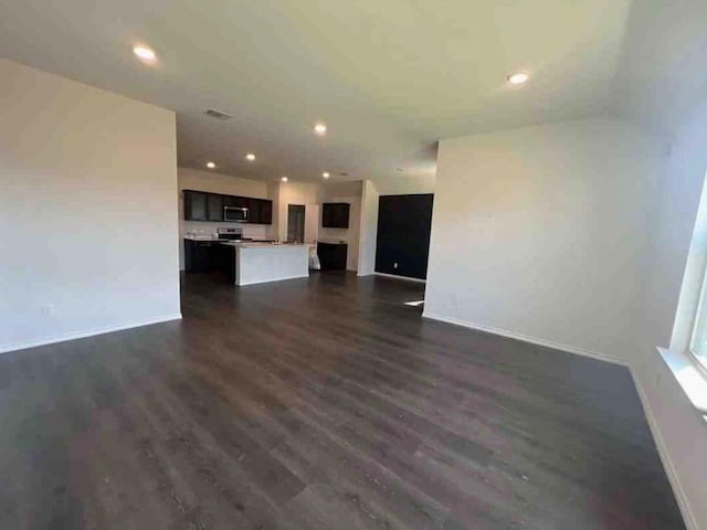 unfurnished living room featuring dark wood-type flooring