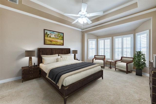 bedroom with a raised ceiling, ceiling fan, light carpet, and ornamental molding