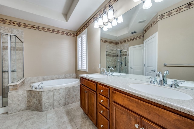 bathroom with tile patterned flooring, vanity, plus walk in shower, and a tray ceiling