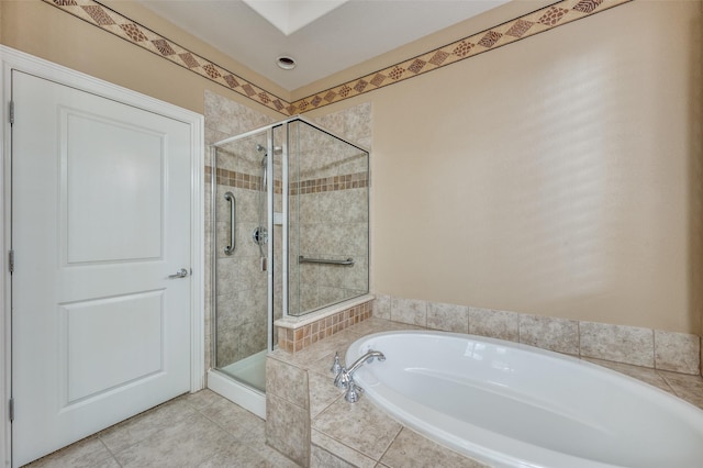 bathroom with tile patterned flooring and shower with separate bathtub