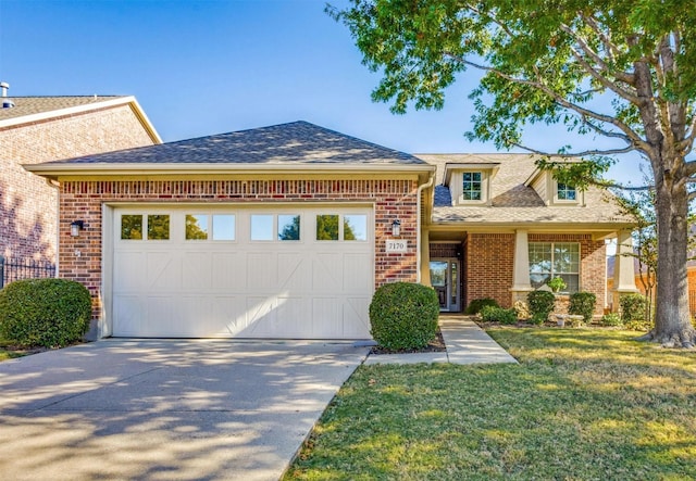 view of front facade featuring a front yard and a garage