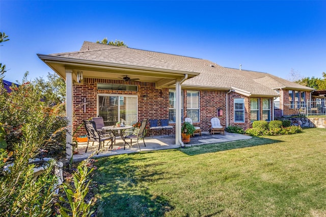 rear view of house featuring a lawn, a patio area, and ceiling fan