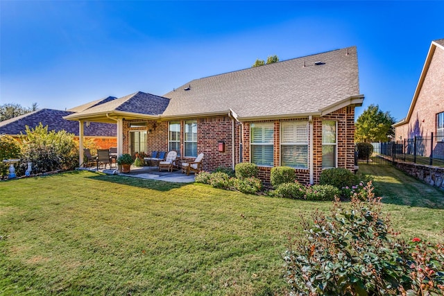 back of property featuring a lawn and a patio