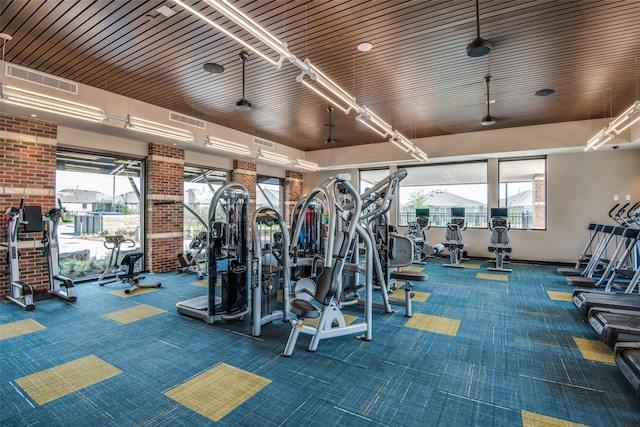 gym with ceiling fan and carpet