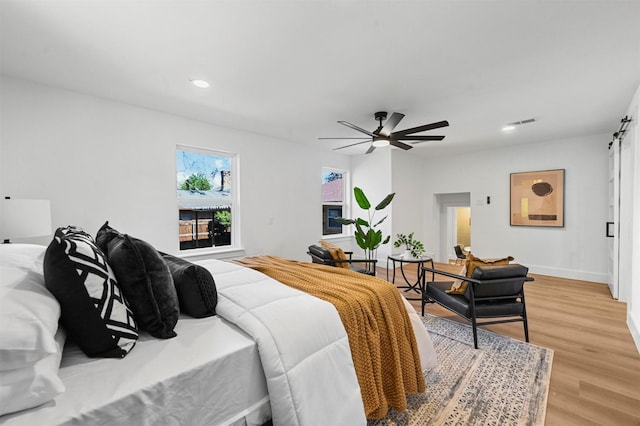 bedroom featuring light hardwood / wood-style flooring and ceiling fan