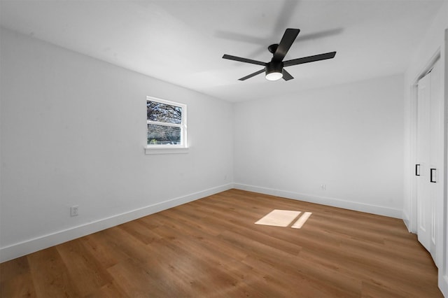 empty room with wood-type flooring and ceiling fan