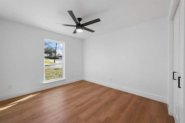 unfurnished room featuring ceiling fan and hardwood / wood-style floors