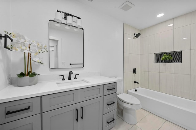 full bathroom with tile patterned flooring, vanity, toilet, and tiled shower / bath