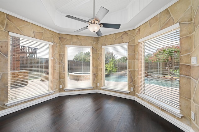 unfurnished sunroom with ceiling fan