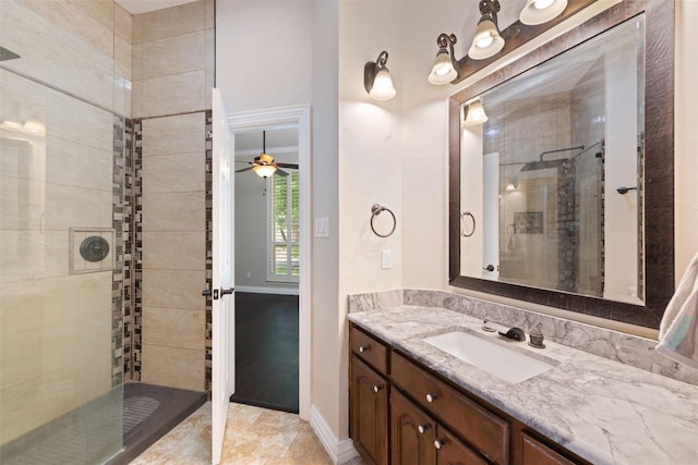 bathroom featuring a tile shower and vanity