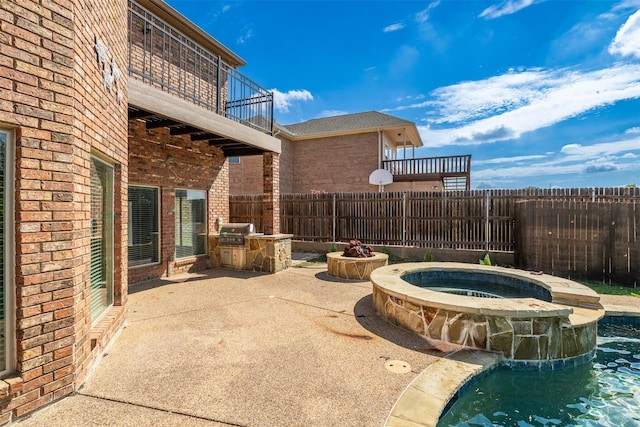 view of patio / terrace featuring an outdoor kitchen, a balcony, grilling area, and a pool with hot tub