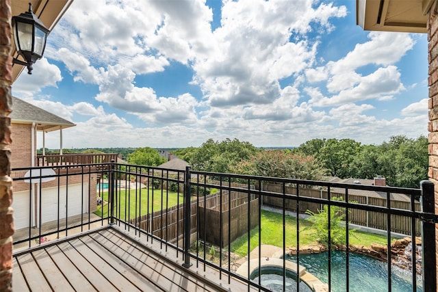 balcony featuring an in ground hot tub and a water view