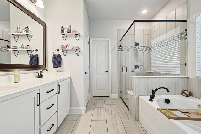 bathroom with vanity and separate shower and tub