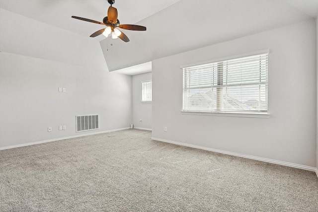 carpeted spare room with ceiling fan and lofted ceiling