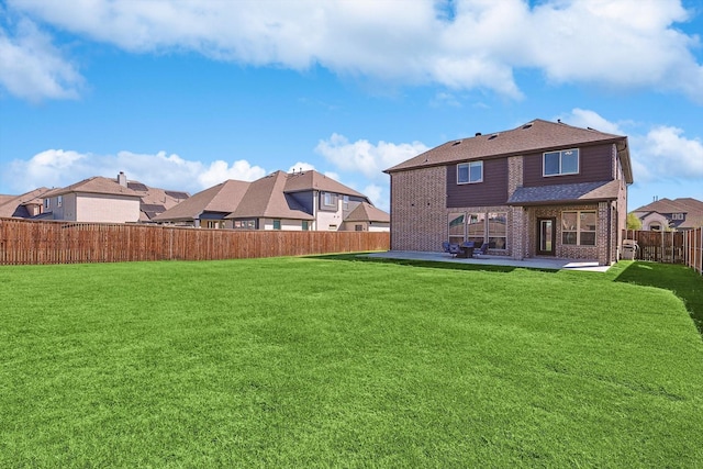 back of property with a lawn and a patio