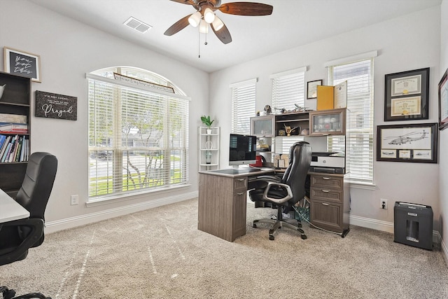 carpeted home office with ceiling fan