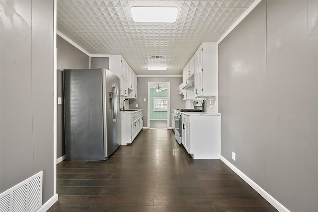 kitchen with sink, white cabinetry, crown molding, appliances with stainless steel finishes, and dark hardwood / wood-style flooring