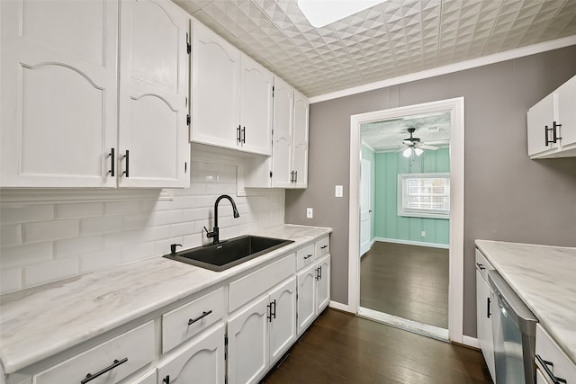 kitchen featuring dark hardwood / wood-style floors, white cabinetry, crown molding, and sink