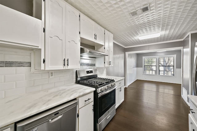 kitchen featuring crown molding, white cabinets, stainless steel appliances, and range hood