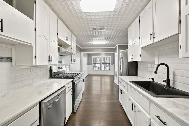 kitchen featuring white cabinetry, sink, appliances with stainless steel finishes, and ornamental molding