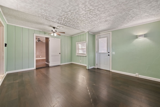 empty room featuring ornamental molding, ceiling fan, and dark hardwood / wood-style flooring