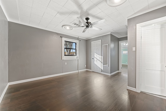 empty room featuring ornamental molding, ceiling fan, and dark wood-type flooring