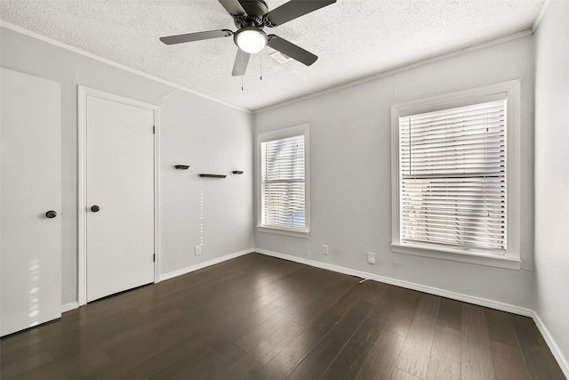 empty room featuring ceiling fan, crown molding, dark hardwood / wood-style floors, and a textured ceiling