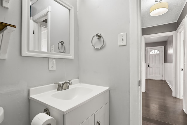 bathroom with vanity, wood-type flooring, and a textured ceiling