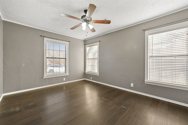 empty room featuring a textured ceiling, ceiling fan, crown molding, and dark hardwood / wood-style floors