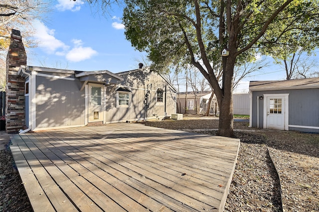 wooden terrace featuring an outdoor structure