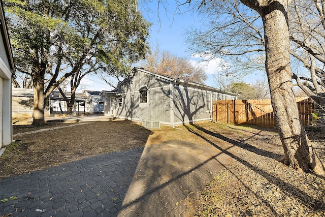 view of property exterior featuring central AC unit and a patio