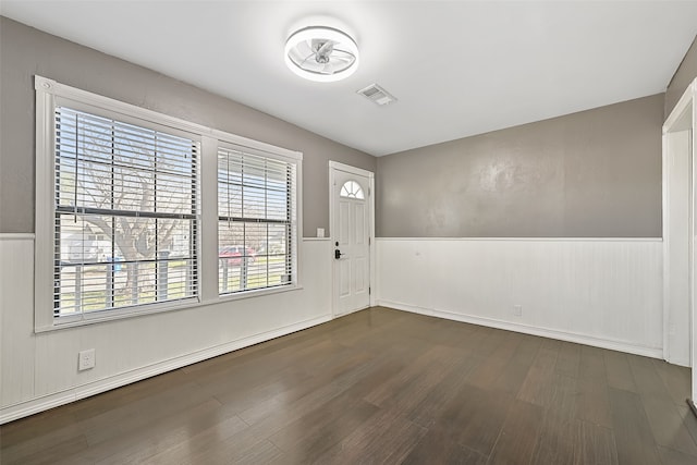 foyer entrance with dark wood-type flooring and a baseboard heating unit