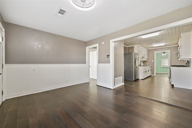 interior space featuring ceiling fan, sink, and dark hardwood / wood-style floors