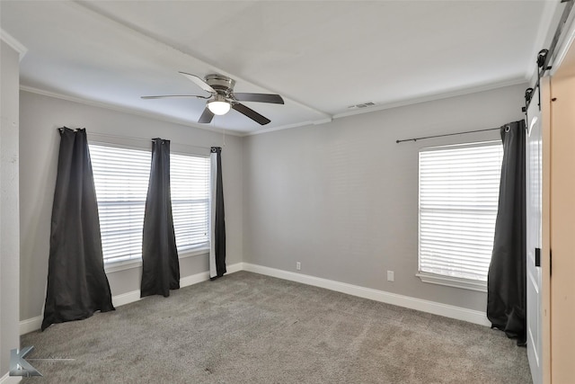 spare room with light colored carpet, ceiling fan, and ornamental molding