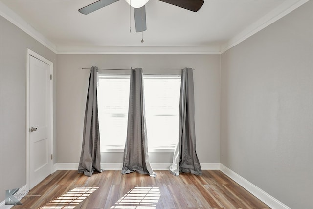 spare room featuring crown molding, ceiling fan, and light wood-type flooring