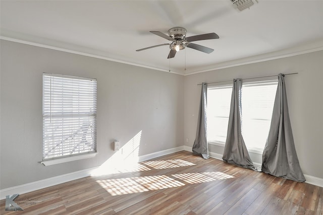 spare room with crown molding, ceiling fan, and light hardwood / wood-style floors