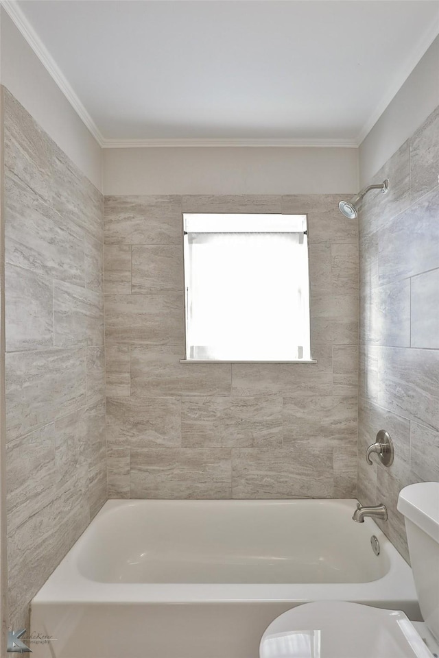 bathroom featuring tiled shower / bath combo, toilet, and crown molding