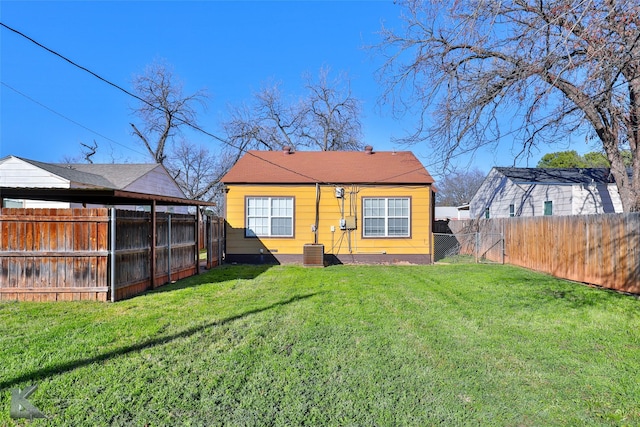 back of property with a lawn and central AC unit