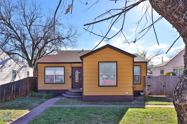 bungalow-style home with a front lawn