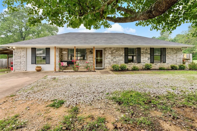 ranch-style house with a porch and a carport