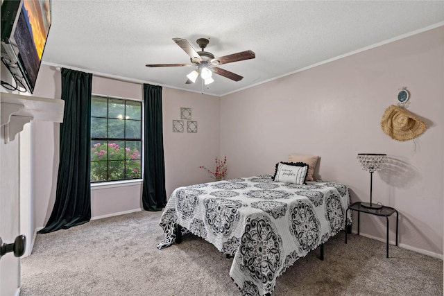 bedroom featuring carpet flooring, ceiling fan, ornamental molding, and a textured ceiling