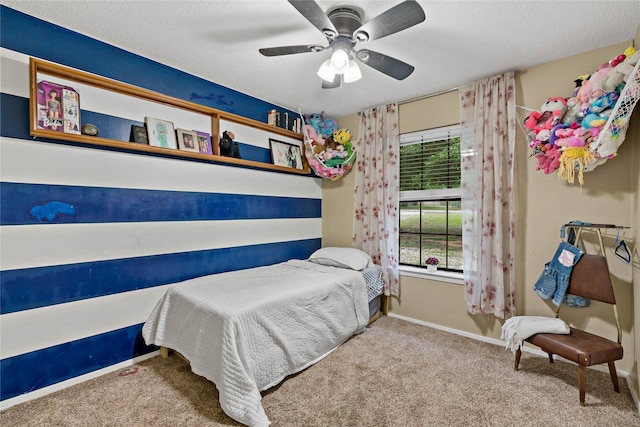 bedroom with a textured ceiling, light colored carpet, and ceiling fan