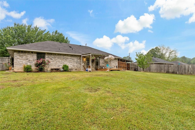 rear view of property with a lawn