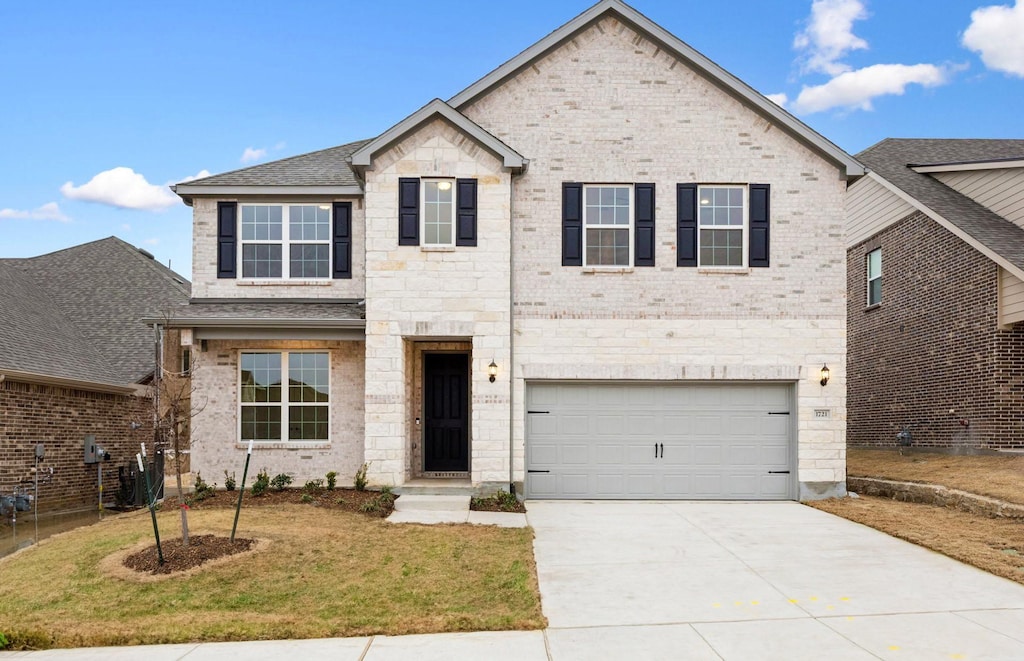 view of front of home featuring a garage and a front lawn