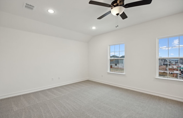 spare room with carpet, lofted ceiling, and ceiling fan