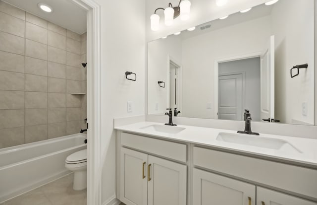 full bathroom featuring toilet, vanity, tile patterned flooring, and tiled shower / bath