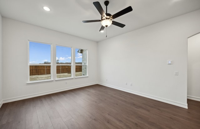 spare room featuring dark hardwood / wood-style floors and ceiling fan