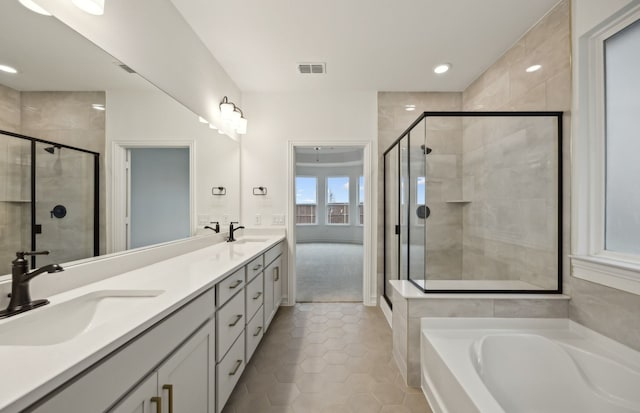 bathroom featuring tile patterned floors, separate shower and tub, and vanity